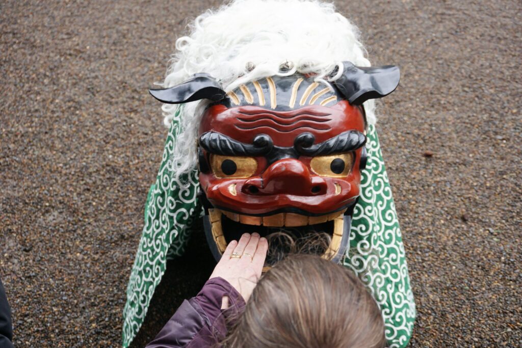 A visitor to Portland Japanese Garden gets a lucky bite during the new year event.